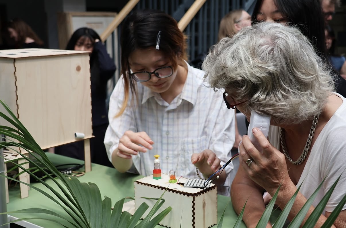 Visitors trying the voice device at a hands-on prototype demonstration